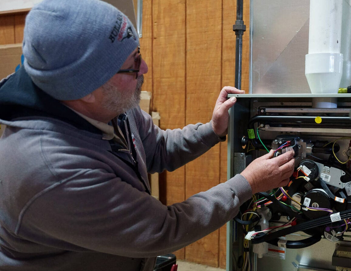Two Bullman Heating and Air technicians working on a unit - Bullman Heating & Air® Two Bullman Heating and Air technicians working on a unit